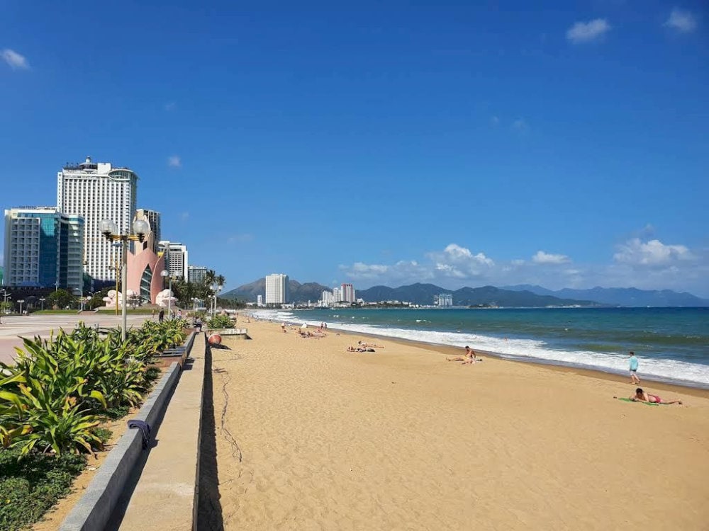 Witness the vibrant coastal life of Nha Trang as locals gather for morning exercises and seaside strolls
